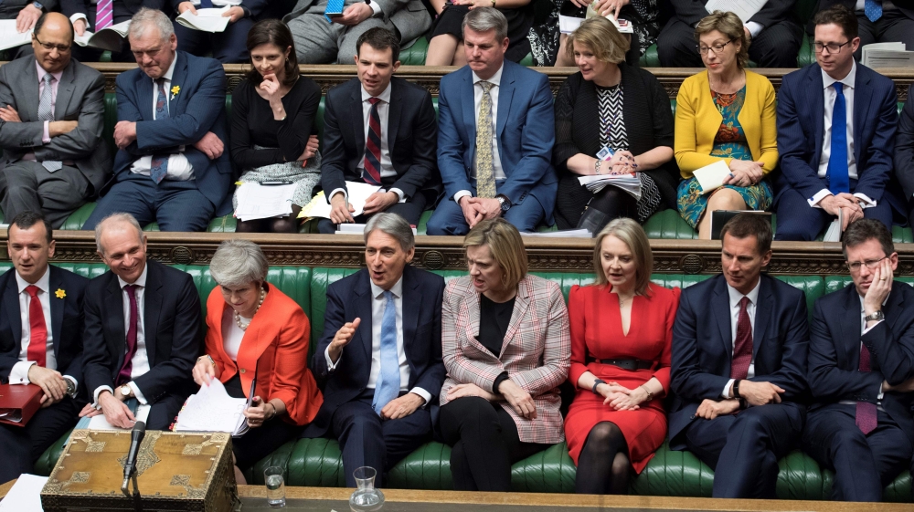 A handout photograph released by the UK Parliament shows Britain's Prime Minister Theresa May (front row 3L) reacting as she sits with members of her Cabinet during the weekly Prime Minister's Questions (PMQs) session in the House of Commons on February 2