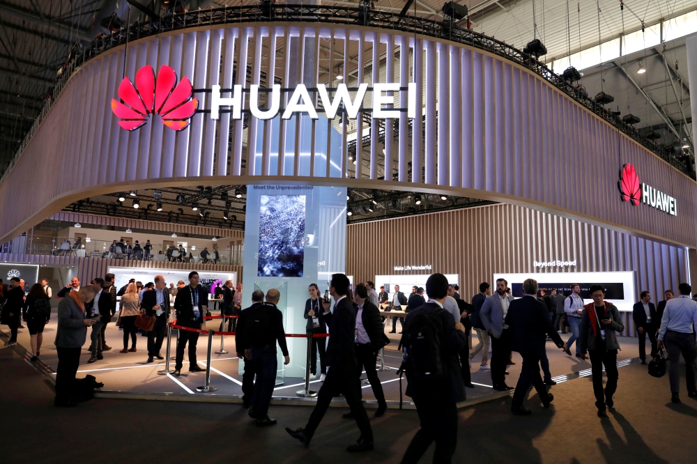 Visitors walk next to Huawei booth at the Mobile World Congress in Barcelona, Spain, February 27, 2019. Reuters/Rafael Marchante