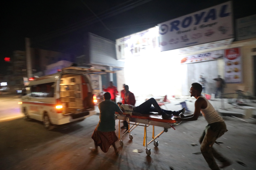 An injured man is evacuated from the scene where a suicide car bomb exploded targeting a Mogadishu hotel in a business center in Maka Al Mukaram street in Mogadishu, Somalia. February 28, 2019. Reuters/Feisal Omar