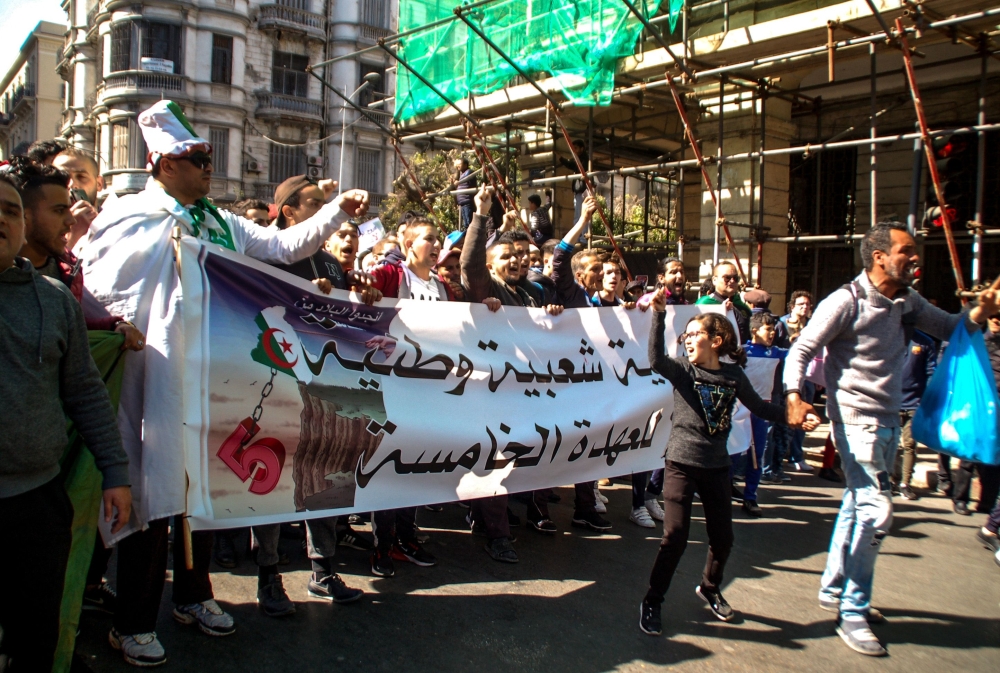Algerians shout slogans and march with banners as they protest during a rally against ailing President Abdelaziz Bouteflika's bid for a fifth term in power, in the northern coastal city of Oran, about 410 kilometres west of the capital Algiers, on March 1