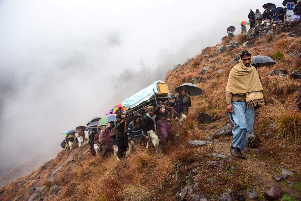 Pakistani Kashmiris carry the coffin of a civilian, who was killed in a gunfight between Indian and Pakistan troops on the Line of Control (LoC), at a funeral ceremony on the outskirts of Muzaffarabad, the capital of Pakistan-administered Kashmir on March