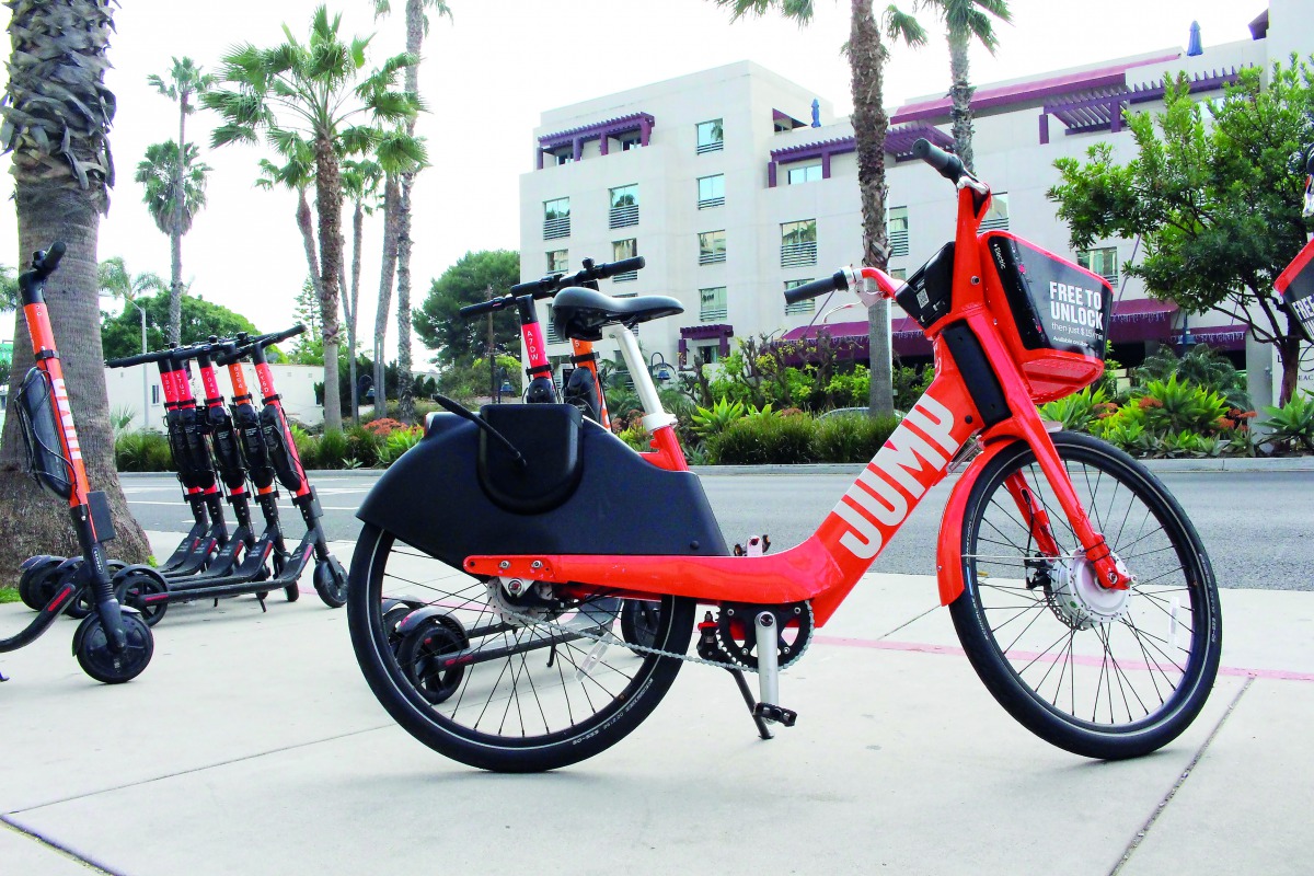 A jump electric bicycle and scooters available to rent by-the-mile through the Uber smartphone application are seen near a road in Santa Monica, California on Febuary 26, 2019 . AFP / Glenn Chapman