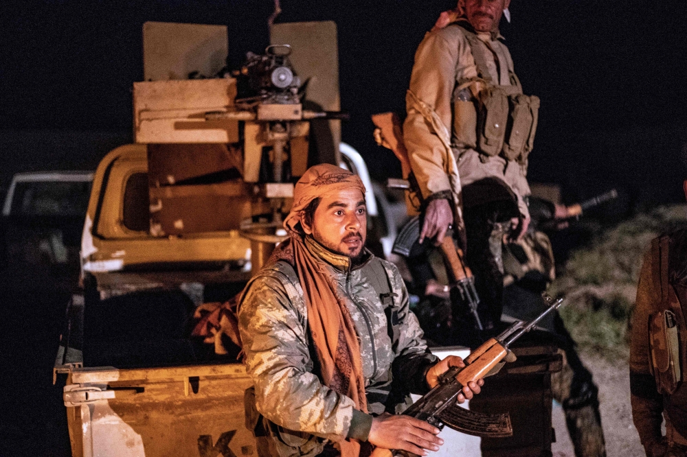 A member of the Syrian Democratic Forces (SDF) stands guard in the Islamic State group's last holdout of Baghouz, in the eastern Syrian Deir Ezzor province on March 2, 2019. AFP / Delil souleiman