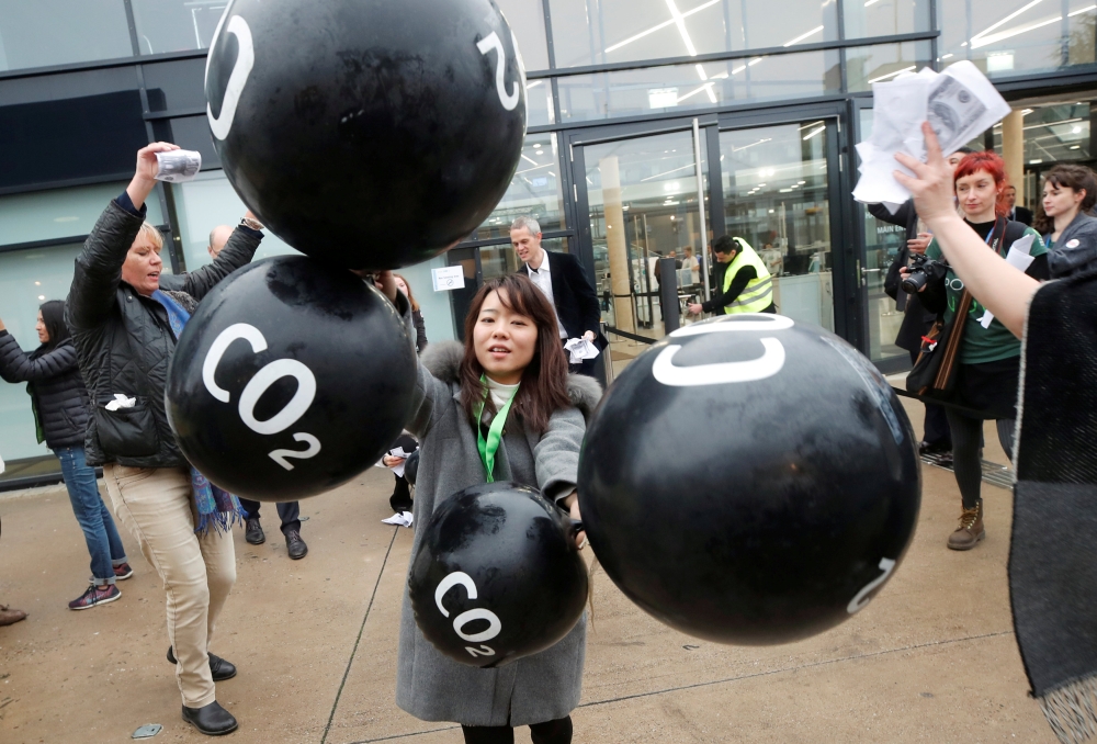 FILE PHOTO: Activists protest against the carbon dioxide emissions trading in front of the World Congress Centre Bonn, the site of the COP23 U.N. Climate Change Conference, in Bonn, Germany, November 17, 2017. REUTERS/Wolfgang Rattay
