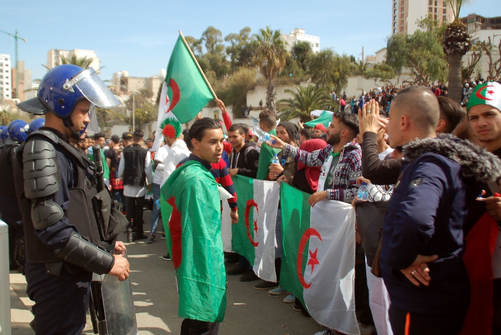 Algerian protestors face anti-riot police during a demonstration in the northern coastal city of Oran, on March 5, 2019 against the ailing president's bid for a fifth term. AFP 

