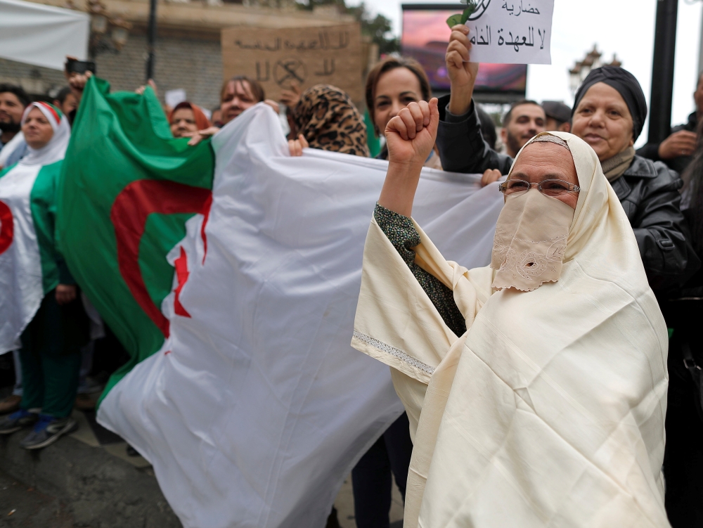 People protest against Algeria's President Abdelaziz Bouteflika, in Algiers, Algeria March 8, 2019. The sign reads: 