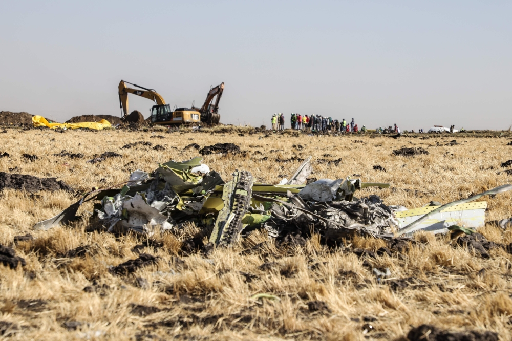 A power shovel digs next to debris at the crash site of Ethiopia Airlines near Bishoftu, a town some 60 kilometres southeast of Addis Ababa, Ethiopia, on March 11, 2019. AFP / Michael TEWELDE