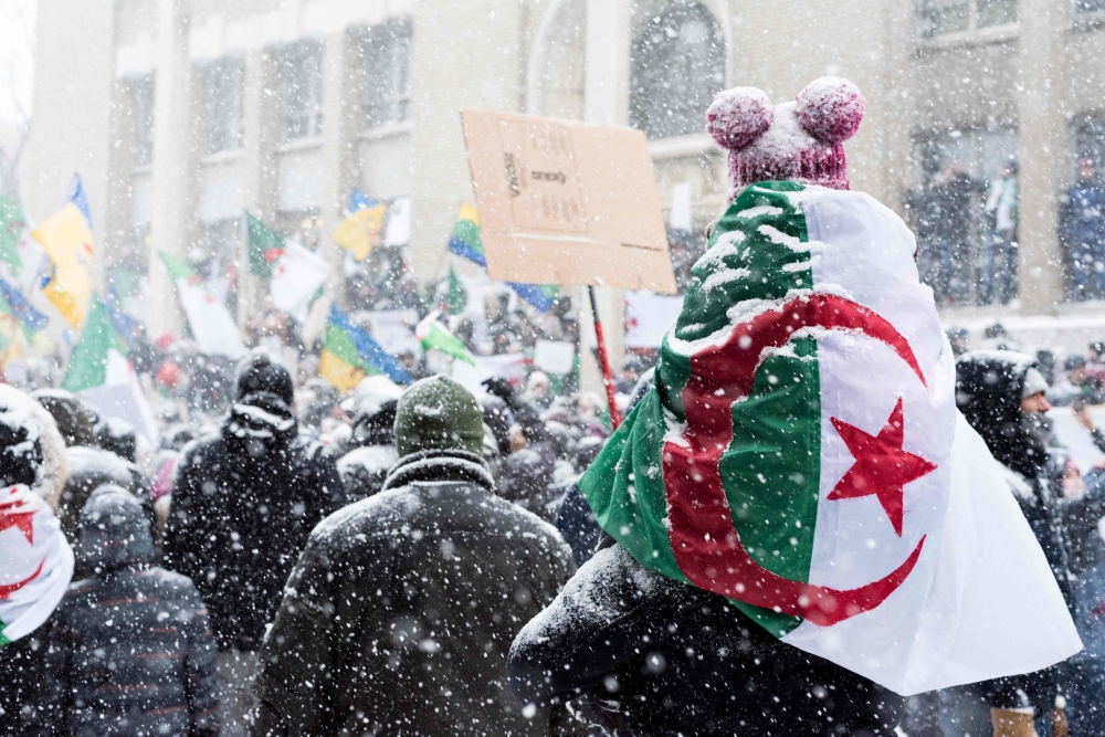 Algerian community protesters gather in Montreal, on March 10, 2019, to demonstrate against the rule of President Abdelaziz Bouteflika, who seeks a fifth term as Algeria head of state after 20 years of power. / AFP / MARTIN OUELLET-DIOTTE