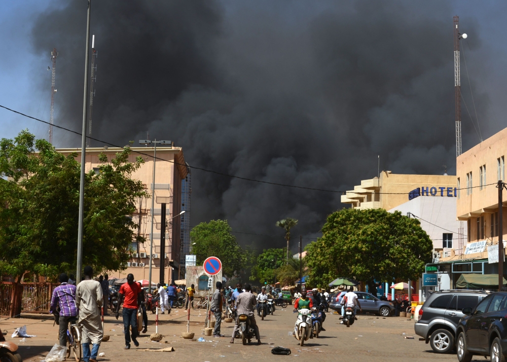 Black smoke rises as the capital of Burkina Faso came under multiple attacks on March 2, 2018 targeting the French embassy, the French cultural centre and military headquarters. (AFP/Ahmed Ouoba) 