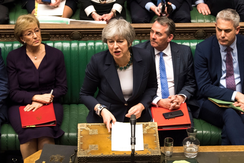 A handout photograph released by the UK Parliament on March 13, 2019 shows Britain's Prime Minister Theresa May responding to the result of a vote in the House of Commons in London on March 13, 2019 in which MPs signalled their opposition to leaving the E