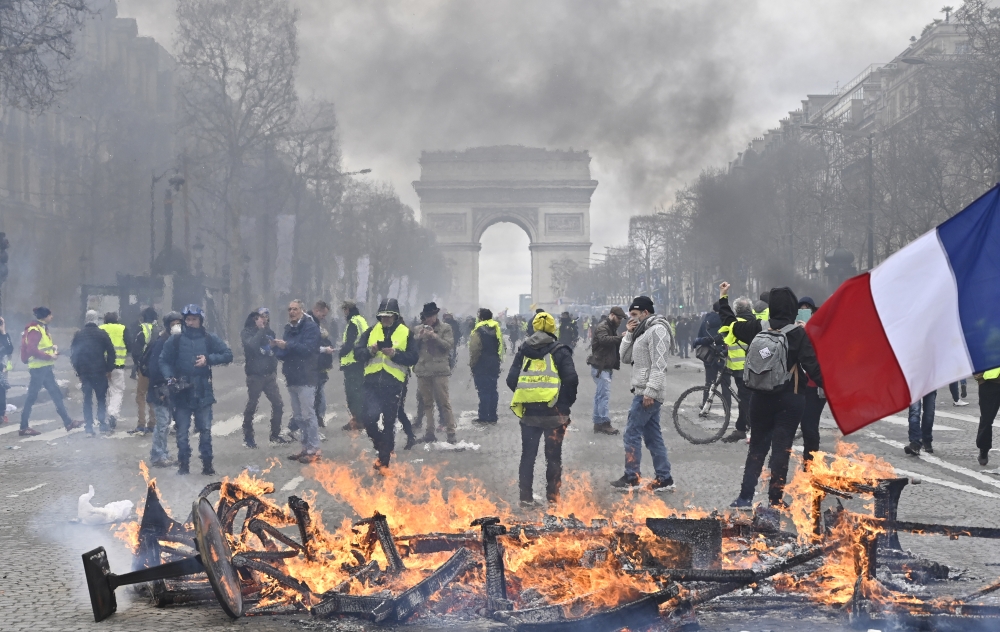 Yellow vests (Gilets jaunes) protesters setup a barricade with fire on the Champs-Elysees during the 18th consecutive Saturday national protest (Act XVIII demonstration) in Paris, France on March 16, 2019. Mustafa Yalç?n - Anadolu