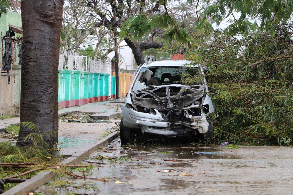 A destroyed car is seen amid the destruction provoked by the passage of the cyclone Idai in Beira, Mozambique, on March 17, 2019. AFP / ADRIEN BARBIER