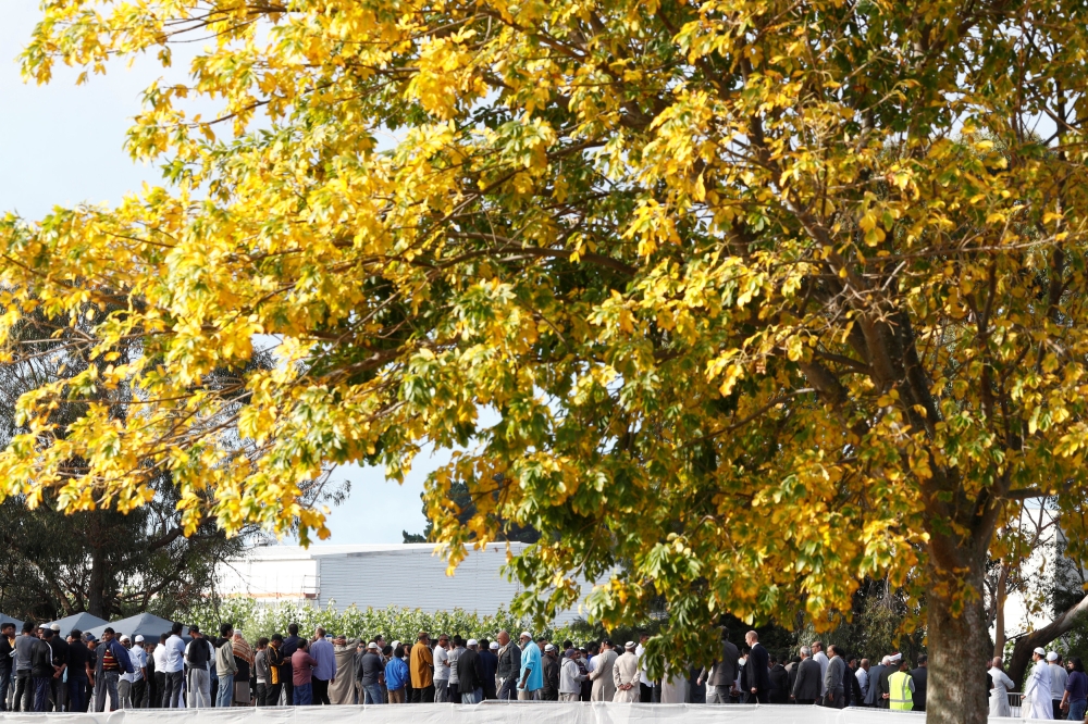 People attend the burial ceremony for the victims of the mosque attacks, at the Memorial Park Cemetery in Christchurch, New Zealand March 20, 2019. Reuters/Edgar Su