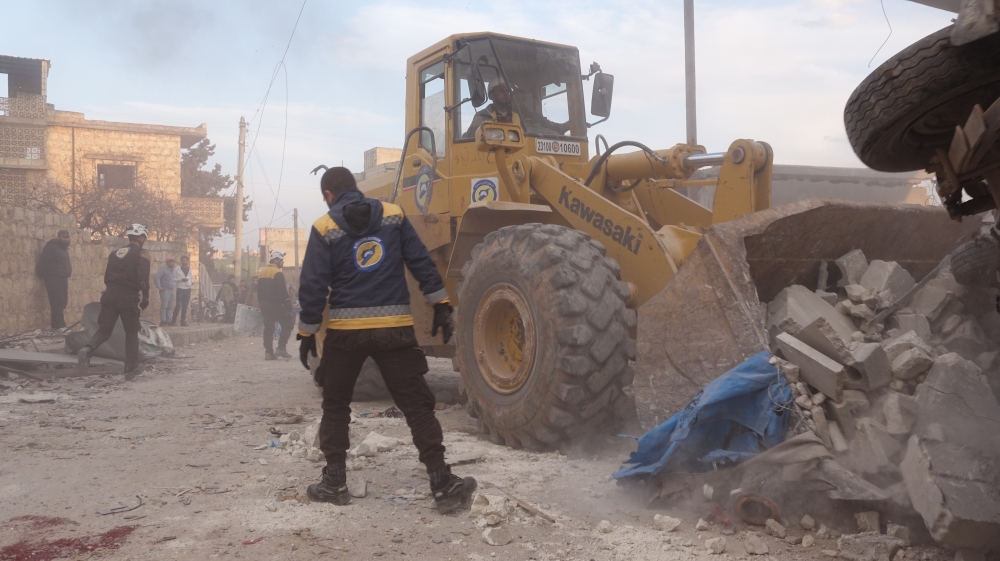Civil defense members conduct a search and rescue operation under the rubbles of demolished buildings after airstrikes hit the residential areas of de-escalation zone Idlib, Syria on March 22, 2019. ( Hasan Muhtar - Anadolu 