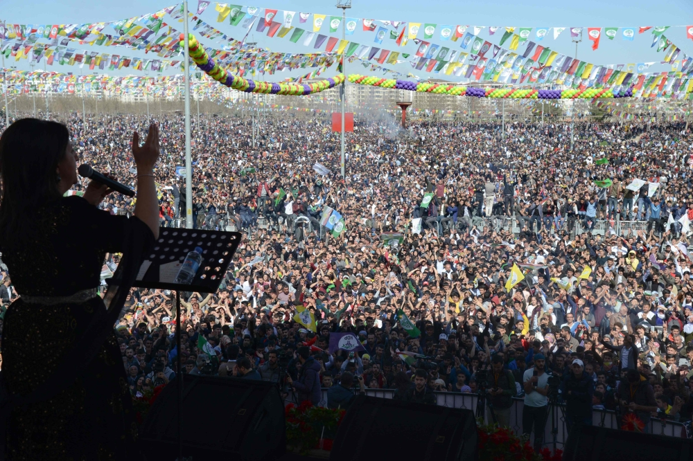 Pervin Buldan, co-leader of the pro-Kurdish Peoples' Democracy Party (HDP) speaks to Turkish Kurds gather around a bonfire during Newroz celebrations for the new year in Diyarbakir, southeastern Turkey, on March 21, 2019. AFP / Ilyas AKENGIN