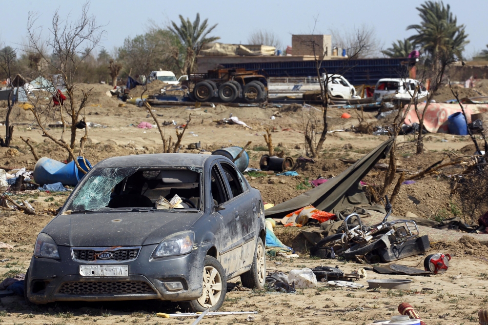 A damaged car is seen after the U.S.-backed forces said they had captured Islamic State's last shred of territory, in the village of Baghouz, Deir Al Zor province, Syria, March 23, 2019. REUTERS/Stringer