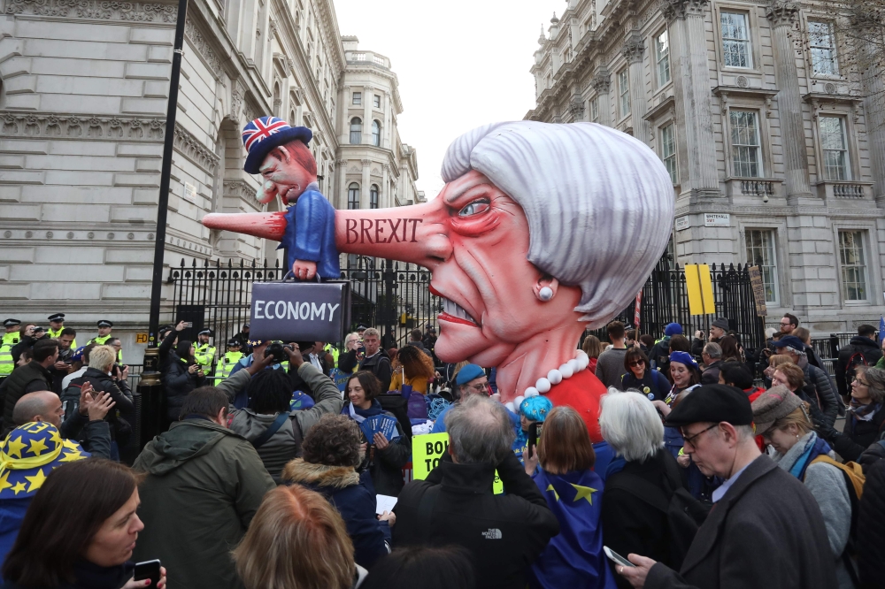 A puppet head of Britain's Prime Minister Theresa May spearing a representation of the British Economy is positioned on Whitehall outside Downing Street after a march and rally organised by the pro-European People's Vote campaign for a second EU referendu