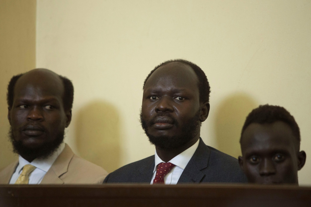 Thirty-five year-old Peter Biar Ajaj (C) looks on during his first appearance before the judiciary headquarters in Juba, South Sudan on March 21, 2019.  AFP/Akuot Chol 