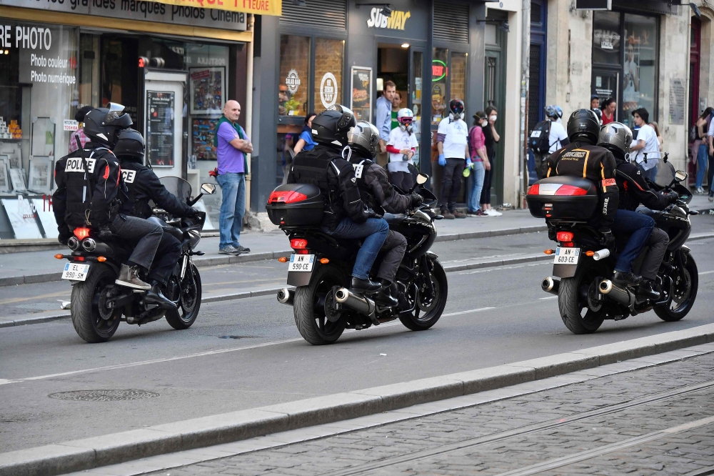 Police officers aboard motorcycles patrol in a street in Bordeaux, southwestern France, on March 23, 2019. AFP / Georges Gobet
 