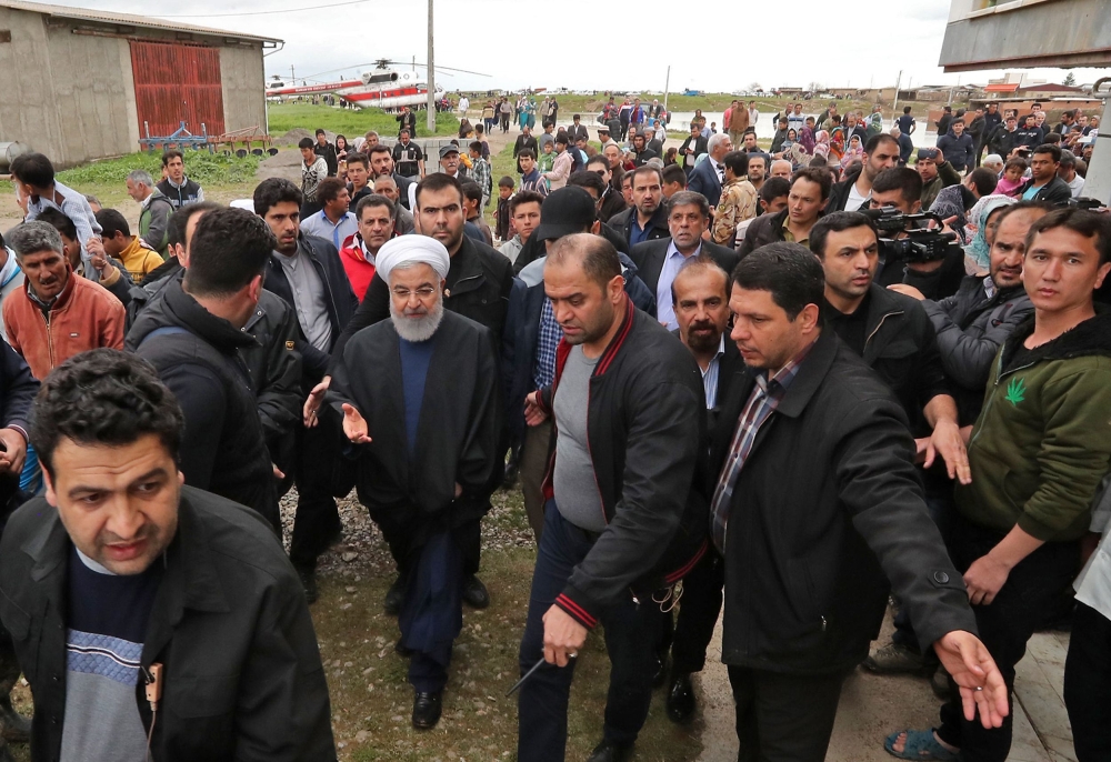 Iranian President Hassan Rouhani (C) during visit to areas affected by floods in the country's northeastern Golestan region. AFP / Iranian Presidency 