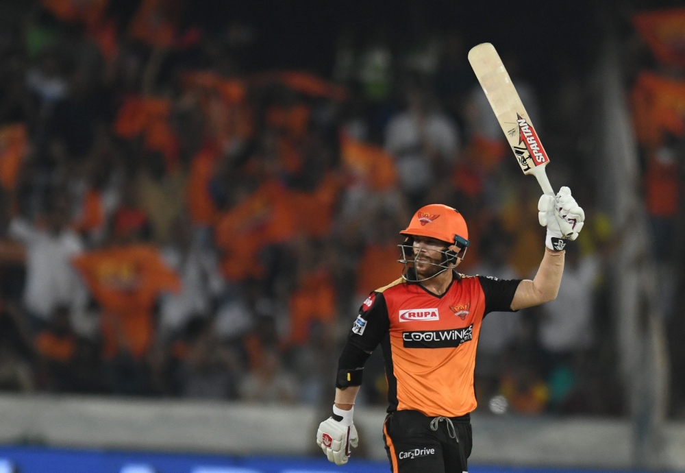Sunrisers Hyderabad cricketer David Warner raisse his bat after scoring fifty (50) runs during the 2019 Indian Premier League (IPL) Twenty20 cricket match between Sunrisers Hyderabad and Rajasthan Royals at The Rajiv Gandhi International Cricket Stadium i