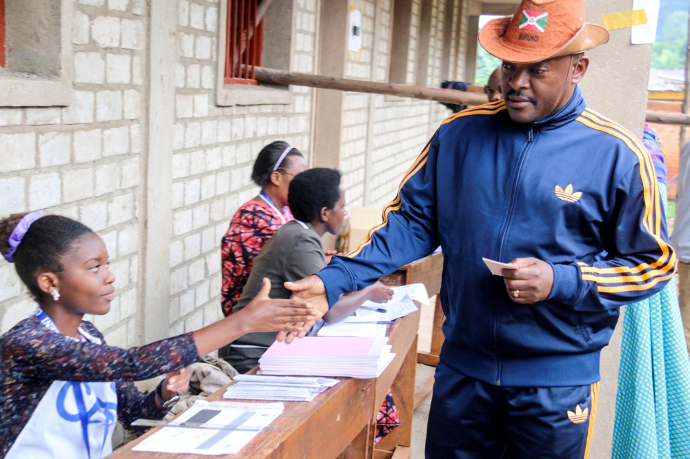 FILE PHOTO: Burundi President Pierre Nkurunziza is registered by an electoral official before casting his ballot at a polling centre during the constitutional amendment referendum at School Ecofo de Buye in Mwumba commune in Ngozi province, northern Burun