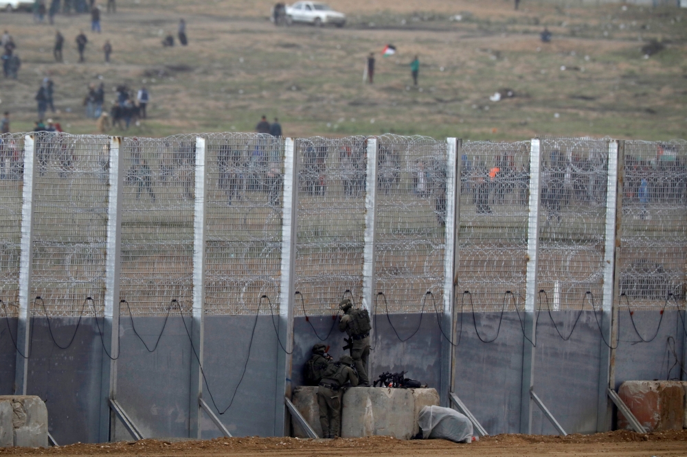 Israeli soldiers clash with Palestinian protestors over the border fence between Israel and the Gaza Strip, as it is seen from its Israeli side March 30, 2019 REUTERS/ Amir Cohen