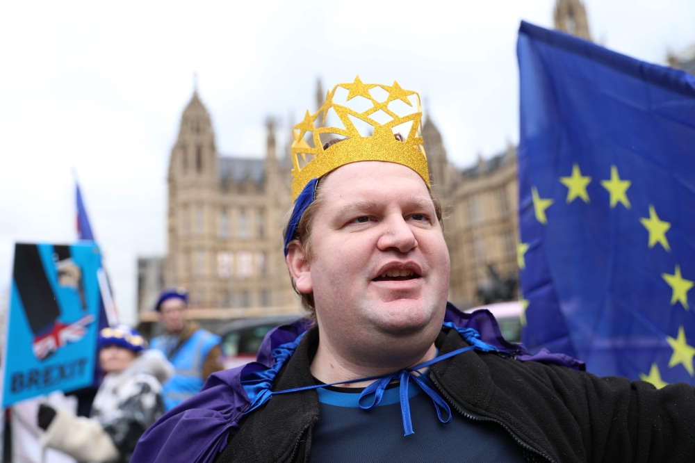 A pro-EU demonstrator wears headgear featuring the EU outside the Houses of Parliament in central London on April 2, 2019. AFP / ISABEL INFANTES