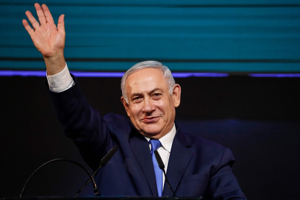 Israeli Prime Minister Benjamin Netanyahu gestures as he appears before supporters at his Likud Party headquarters in the Israeli coastal city of Tel Aviv on election night early on April 10, 2019. AFP / Thomas Coex 