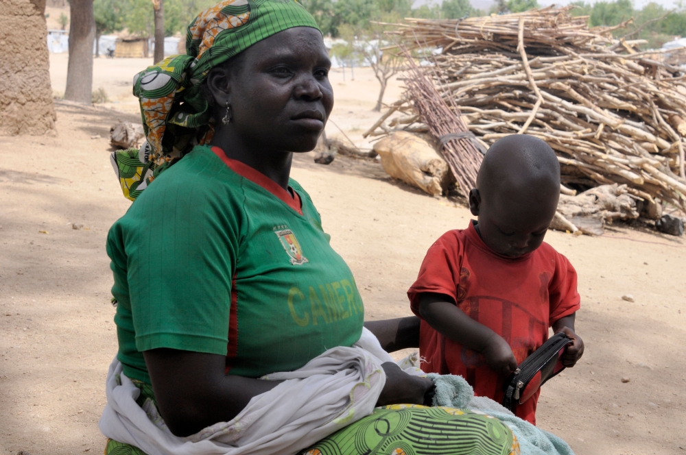 Bourtaye Bigue, 36-years-old, poses with one of her children on March 22, 2019 in the Zamai displaced camp in the Cameroon extreme north region. AFP/Reinnier Kaze 