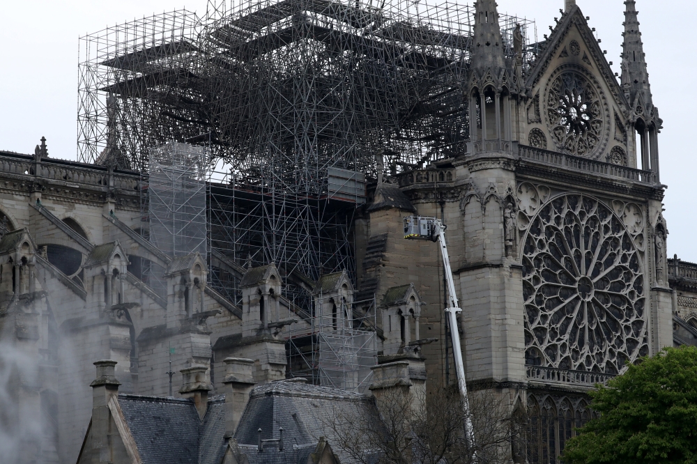 Firefighters work at Notre-Dame Cathedral in Paris, France April 16, 2019. A massive fire consumed the cathedral on Monday, gutting its roof and stunning France and the world. REUTERS/Yves Herman