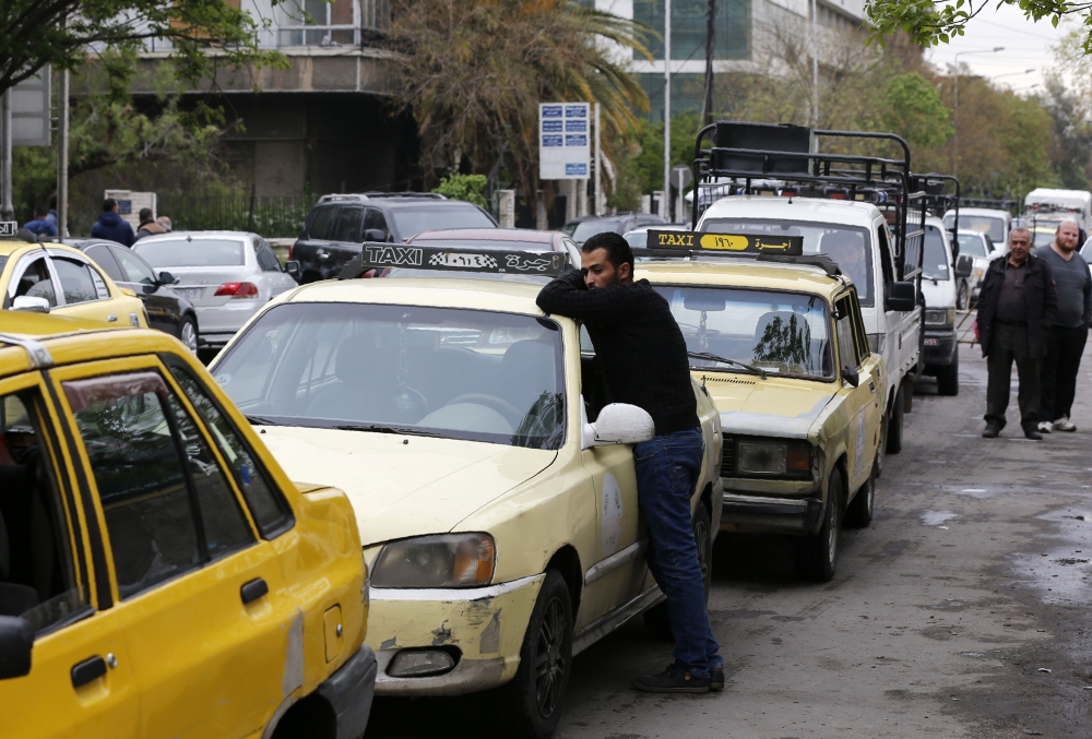 Drivers queue for gasoline in front of a petrol station in the Syrian capital Damascus on April 16, 2019.  AFP / LOUAI BESHARA