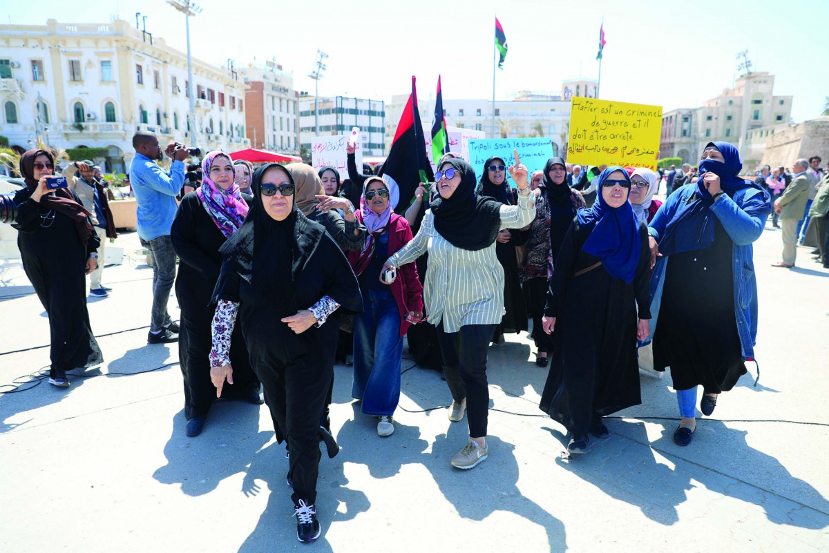 Libyan women shout slogans during a demonstration to demand an end to the Khalifa Haftar's offensive against Tripoli, at Martyrs' Square in Tripoli, Libya April 17, 2019. The sign reads, 