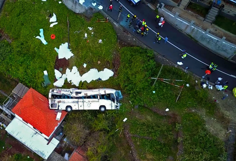 A video grab obtained from drone footage shows the wreckage of a tourist bus that crashed on April 17, 2019 in Canico, on the Portuguese island of Madeira. AFP / STRINGER