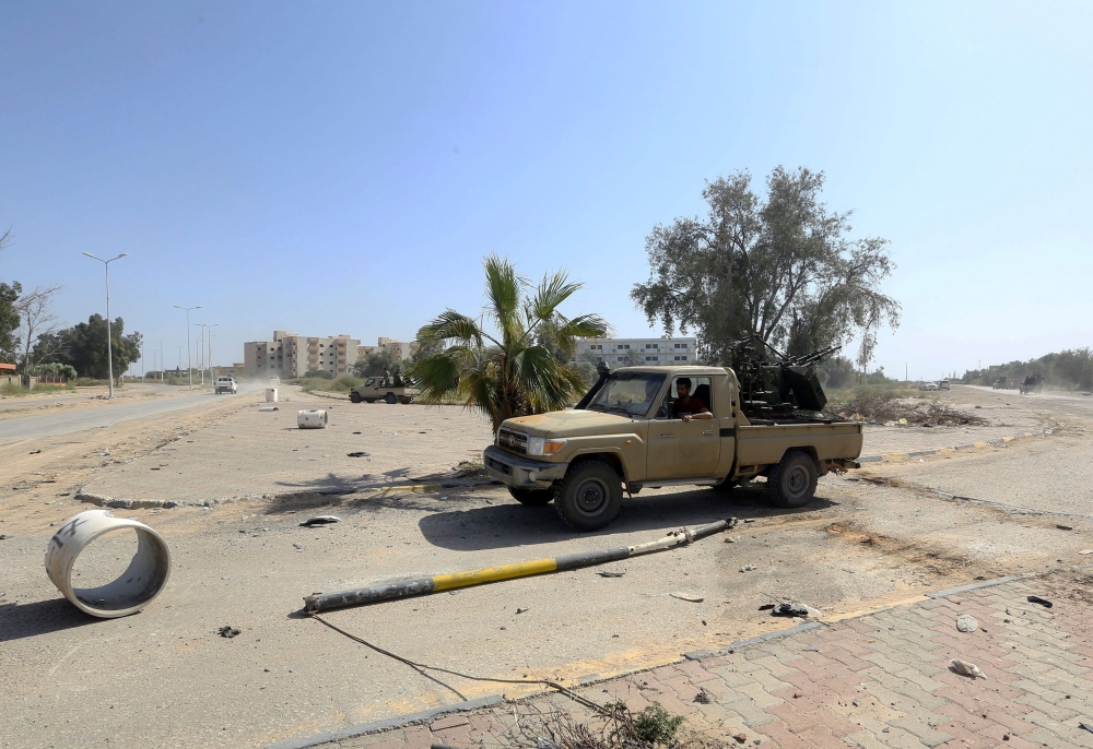 Forces loyal to Libya's Government of National Accord (GNA) gesture on April 18, 2019, after taking control of the area of al-Aziziyah, located some 40 kilometres south of the Libyan capital Tripoli, following fierce clashes with forces loyal to strongman