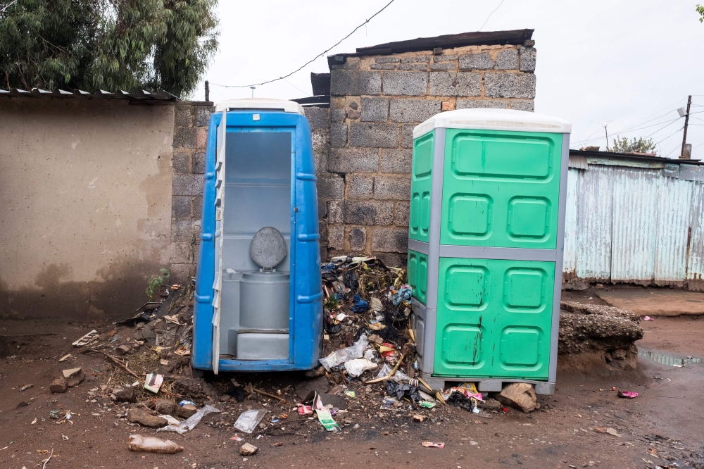 Portable toilets are photographed in an alley way between houses on April 5, 2019 in Kliptown near Soweto. AFP / Wikus De Wet 
