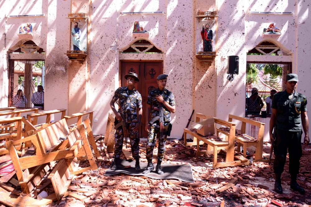Sri Lankan soldiers look on inside the St Sebastian's Church at Katuwapitiya in Negombo on April 21, 2019, following a bomb blast during the Easter service that killed tens of people. AFP