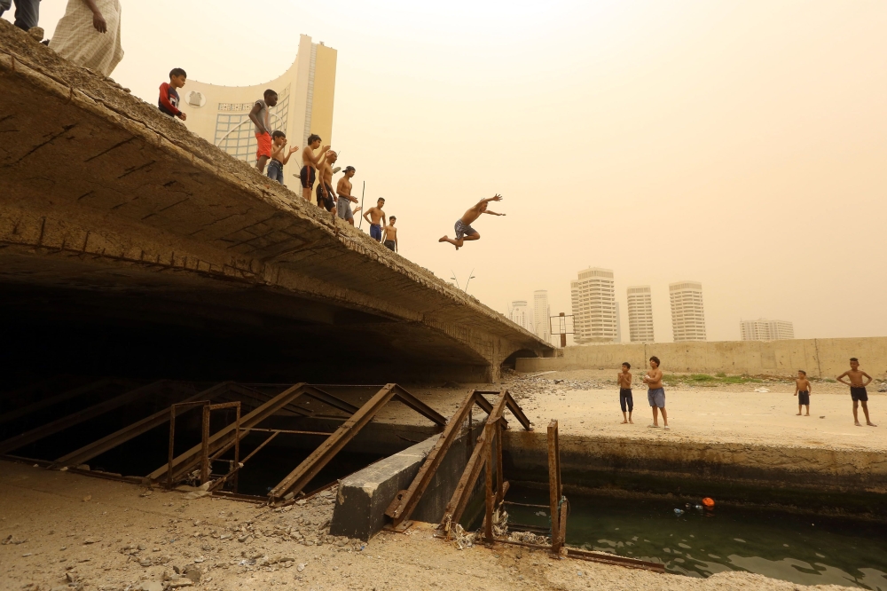 Libyan children play near the port of Tripoli on April 22, 2019. AFP / Mahmud Turkia
 