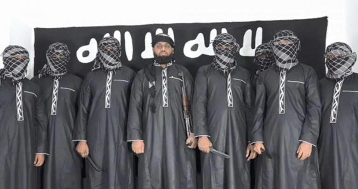 An image grab taken from a press release issued on April 23, 2019 by the Islamist State (IS) group's propaganda agency Amaq, allegedly shows eight men it said carried out a string of deadly suicide bomb blasts on Easter Sunday in Sri Lanka, lined up at an