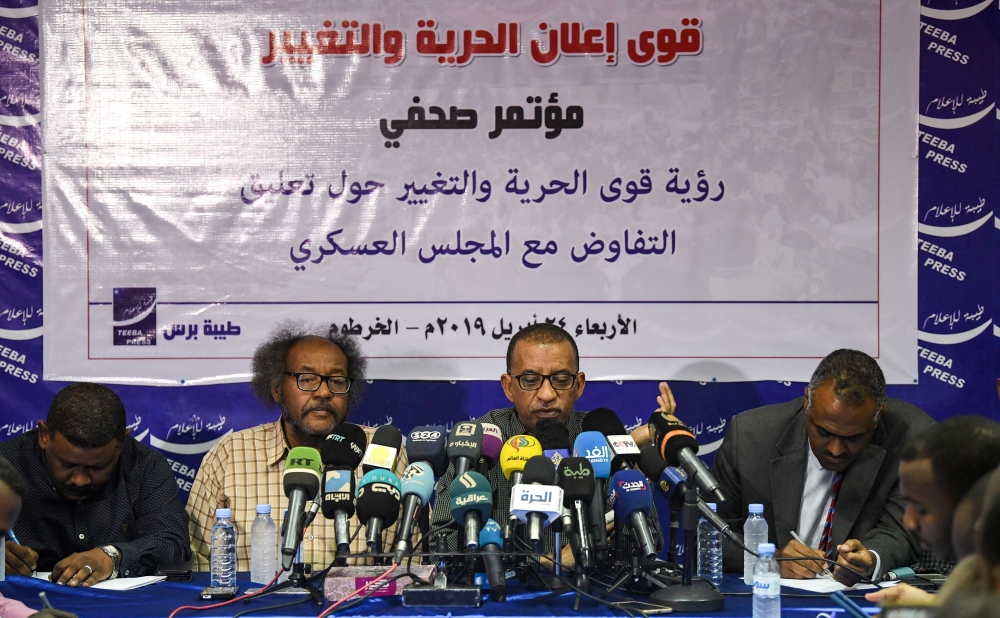 Sudanese civil society activists Muawia Shaddad (C-L) and Omar el-Digeir (C-R), two of the leaders from the protest movement led by the Alliance for Freedom and Change, give a press conference in the capital Khartoum on April 24, 2019.   AFP / OZAN KOSE