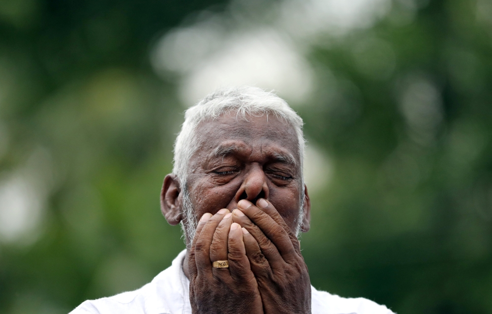 A man mourns at the funeral of Dhami Brindya, 13, victim of a string of suicide bomb attacks on churches and luxury hotels on Easter Sunday, in Negombo, Sri Lanka April 25, 2019. Reuters/Athit Perawongmetha
 