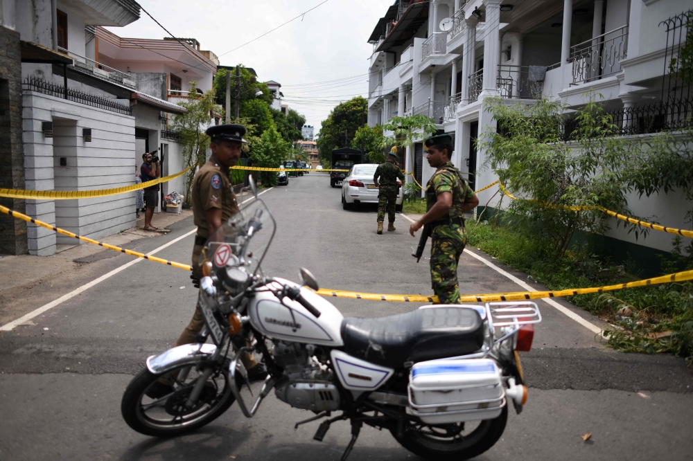 In this photo taken on April 23, 2019, Sri Lankan security personnel stand guard around the house of one of the suspected suicide bombers in Colombo.  AFP / Mohd Rasfan