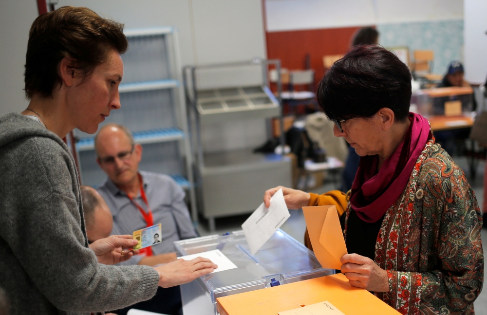 A woman casts her vote at a polling station during Spain's general election in Madrid, Spain, April 28, 2019. REUTERS/Jon Nazca
