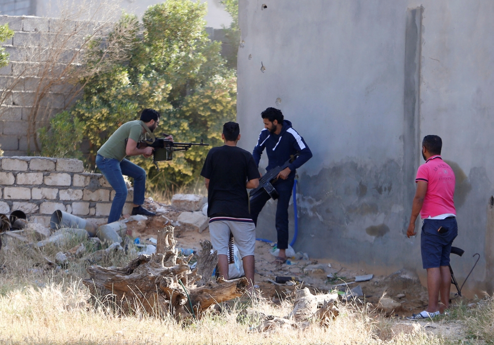 Members of the Libyan internationally recognised government forces fire during a fight with Eastern forces in Ain Zara, Tripoli, Libya April 28, 2019. Reuters/Ismail Zitouny