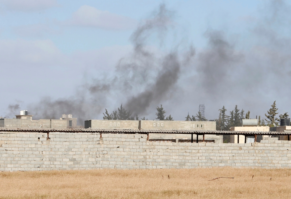 Smoke rises during a fight between members of the Libyan internationally recognised government forces and Eastern forces in Ain Zara, Tripoli, Libya April 28, 2019. REUTERS/Ismail Zitouny