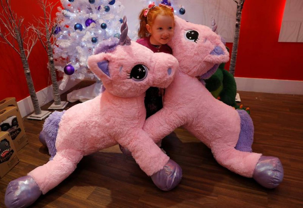 A girl plays with Unice Unicorn, at the launch of Hamleys top Christmas toys launch in London, Britain, September 26, 2018. Reuters/Peter Nicholls 