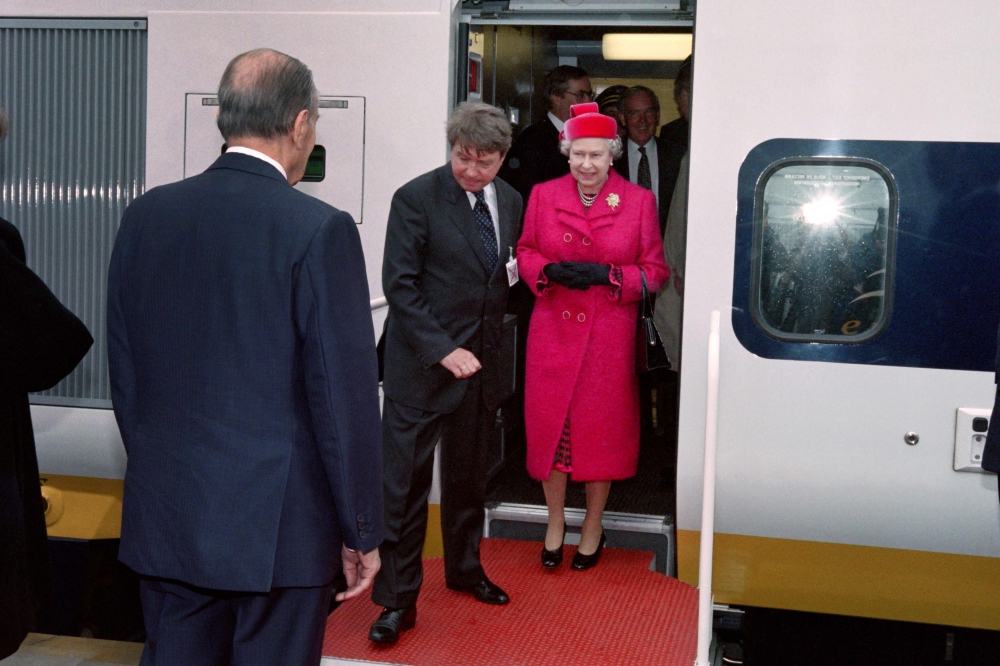  In this file photograph taken on May 6, 1994, French President François Mitterrand (R) welcomes Britain's Queen Elizabeth II (C) as she disembarks from the inaugural Eurostar train during the inauguration of the Channel Tunnel at Coquelles in northern Fr