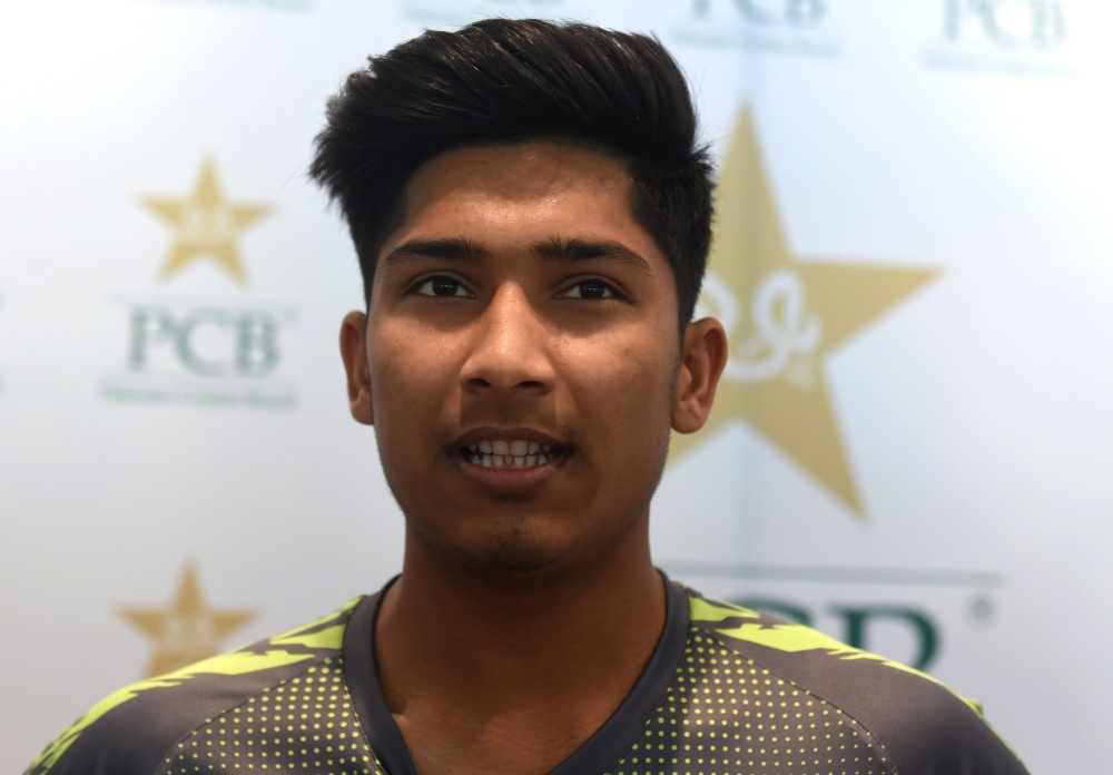 Pakistani right-arm fast bowler Mohammad Hasnain speaks to journalists at the Gaddafi Cricket Stadium in Lahore. (AFP / ARIF ALI)