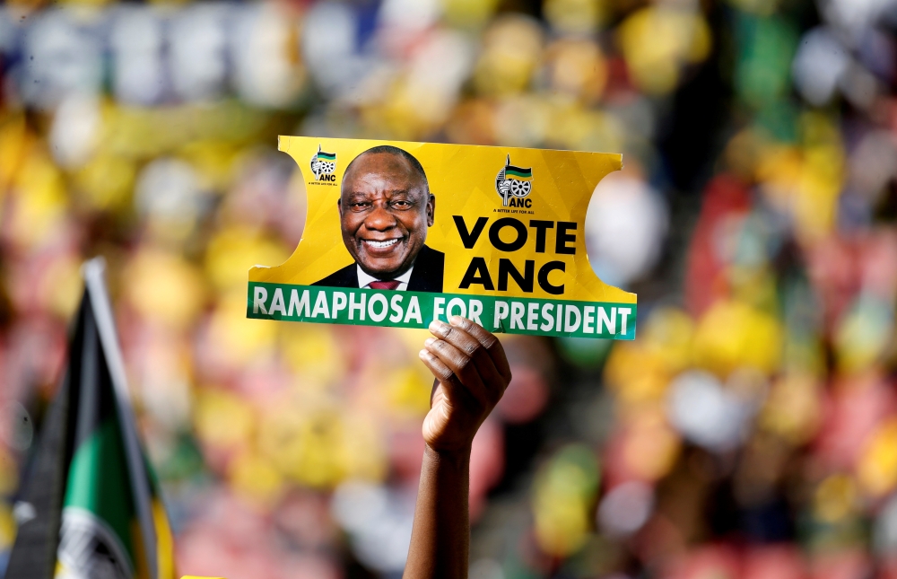 A supporter holds a placard with the face of President of South Africa's governing African National Congress Cyril Ramaphosa, during the party's final rally at Ellis Park Stadium in Johannesburg, South Africa, May 5, 2019. (REUTERS/Siphiwe Sibeko/File Pho