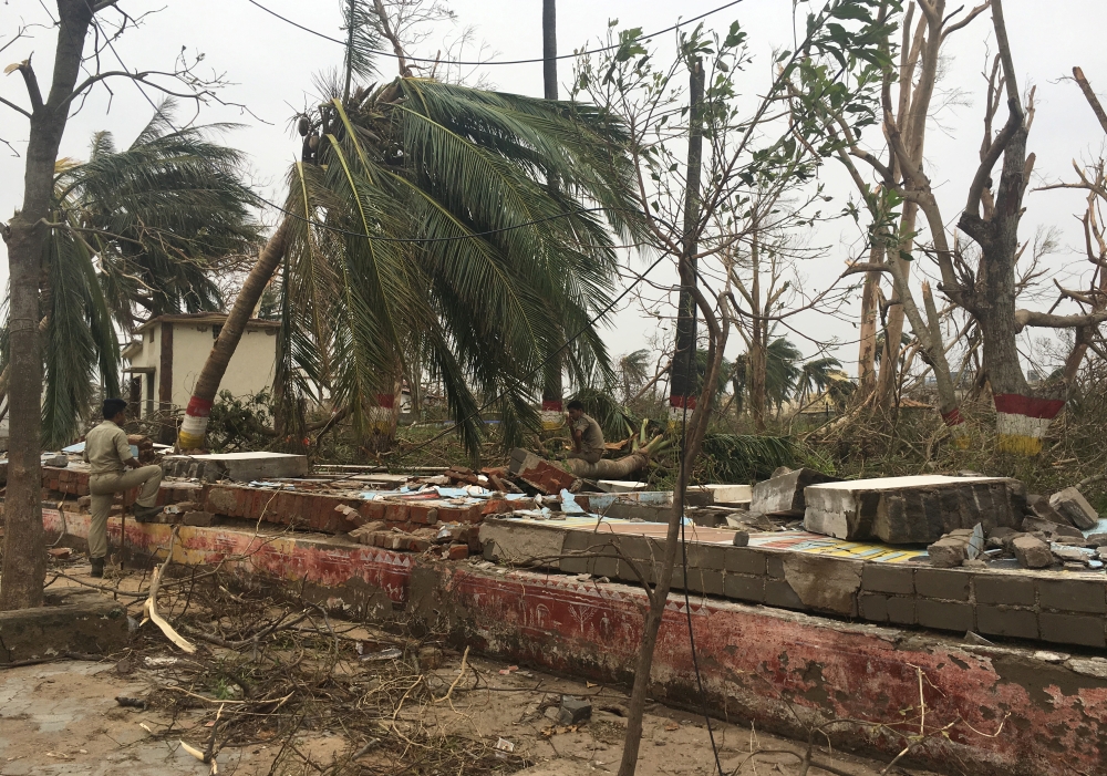 A police officer rests as he sits on a damaged wall following Cyclone Fani in Puri, in the eastern state of Odisha, India, May 5, 2019. (REUTERS/Jatindra Dash)